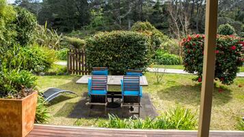 Relax on the patio surrounded by lush greenery and enjoy the serene atmosphere.