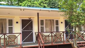 A building with a covered porch, a staircase, and a tree in front. - Regal Hetauda Resort Pvt. Ltd. (Hetauda)