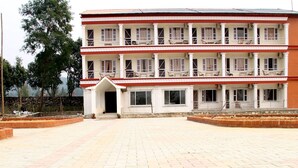 A multi-story building with a symmetrical facade, featuring balconies with railings and windows. - Regal Hetauda Resort Pvt. Ltd. (Hetauda)