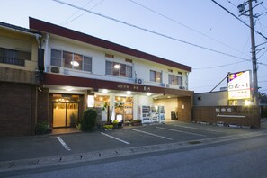 A two-story building with a parking lot in front. - Tamagawa Ryokan (Tahara)