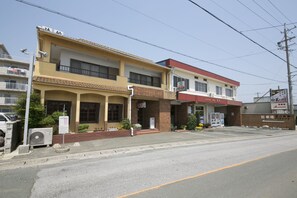 A two-story building with a yellow facade and a red roof. - Tamagawa Ryokan (Tahara)