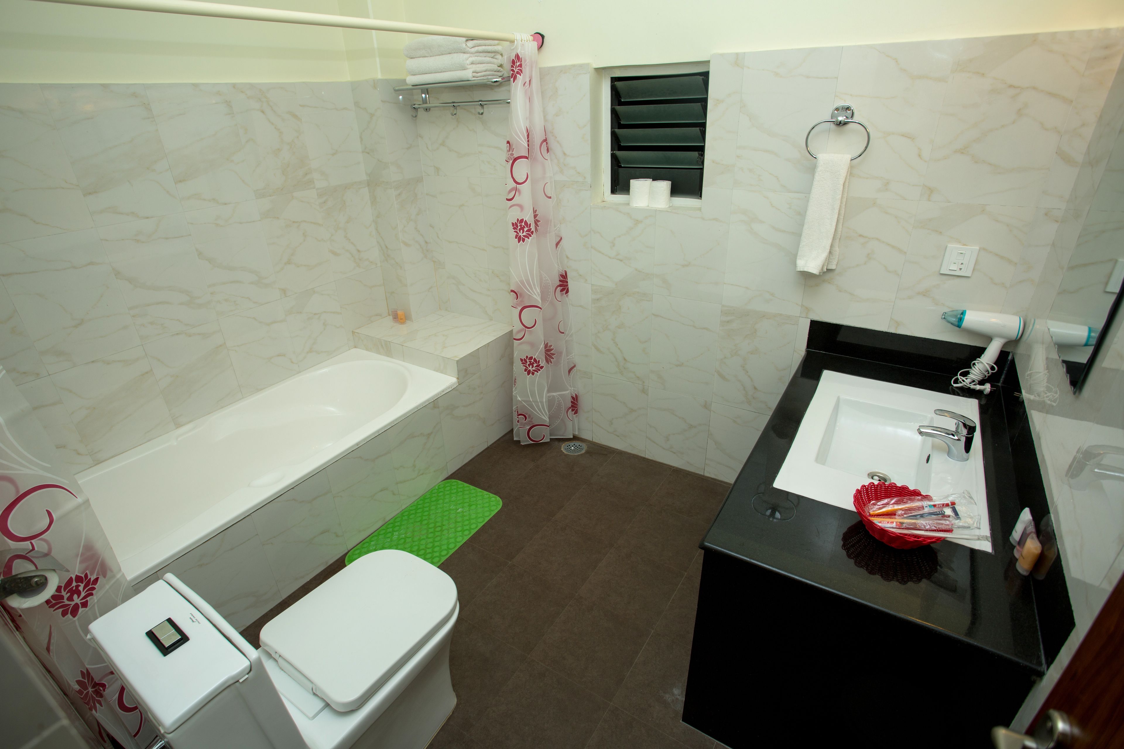 deluxe double room, 1 king bed | bathroom | free toiletries, hair dryer, slippers, towels