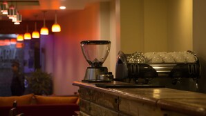 A bar area with a blender, ice shakers, and a cash register. - Asian Boutique Hotel (Kathmandu)