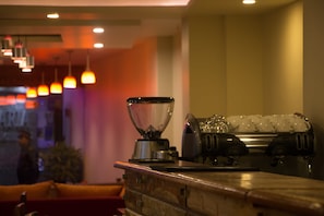 A bar area with a blender, ice shakers, and a cash register. - Asian Boutique Hotel (Kathmandu)