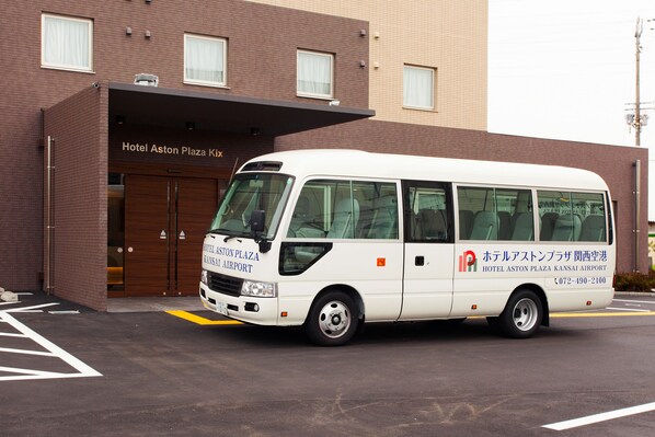 A white van parked in front of a hotel with a sign reading "Hotel Aston Plaza Kansai Airport." - Hotel Aston Plaza Kansai Airport (Izumisano)