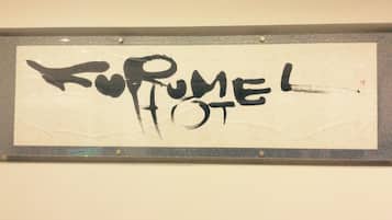 A sign with the text "KURME HOTEL" in black, stylized font on a beige background.