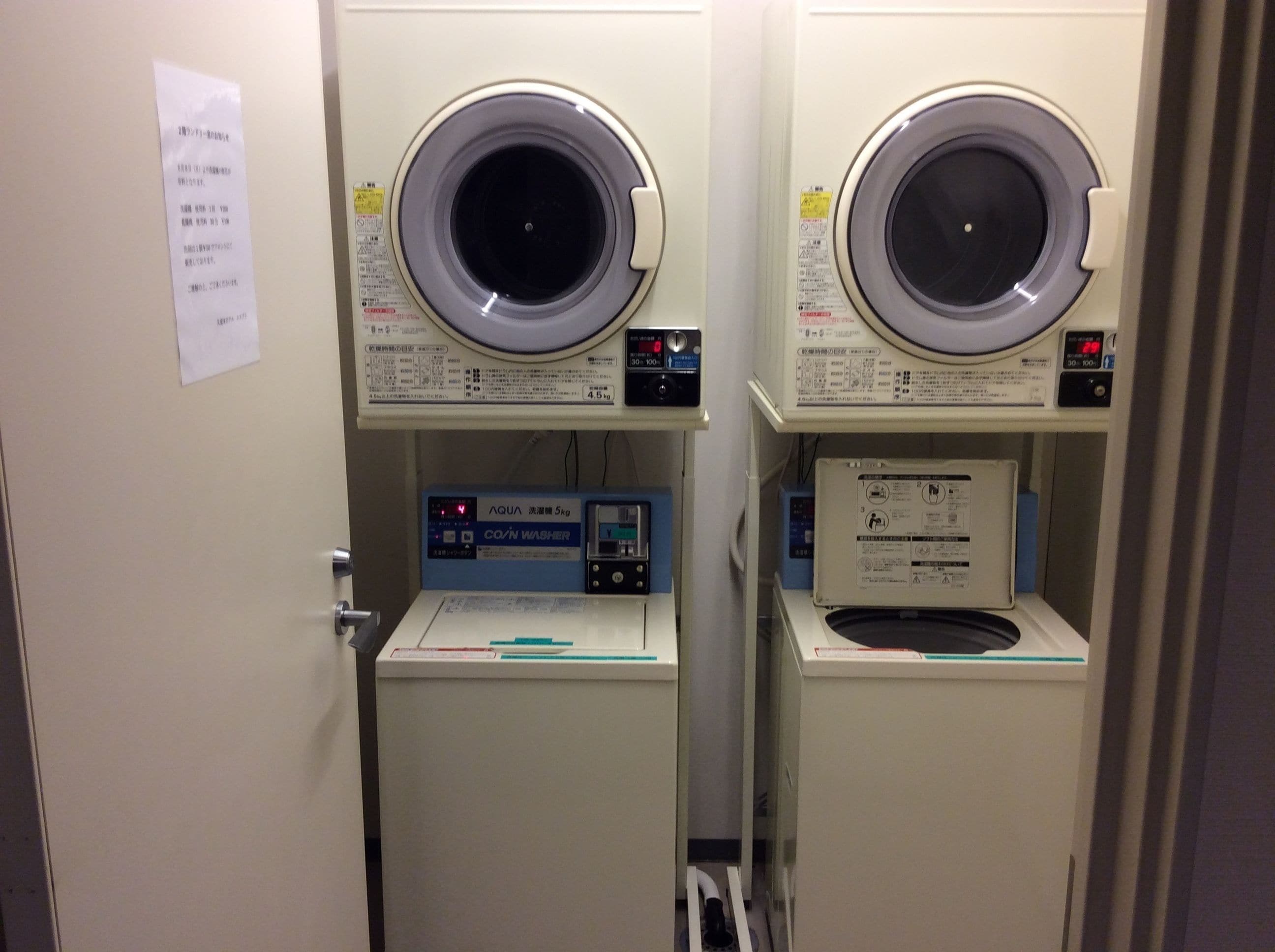 Two front-loading washing machines with control panels, a water level indicator, and a label for the 'AQUA' brand.