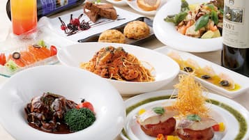A variety of dishes on a table, including a bottle of wine.