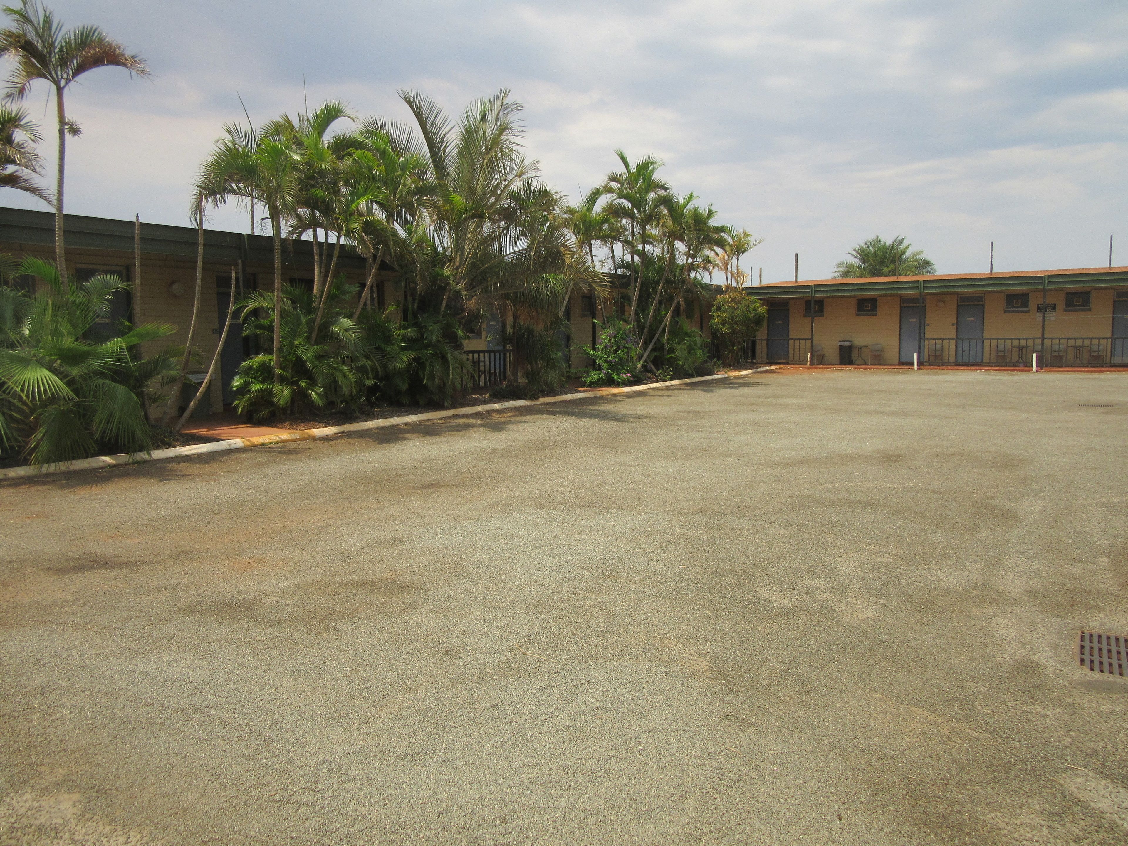 A large, open parking area with a building in the background.