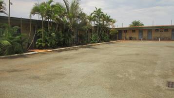 A large, open parking area with a building in the background.