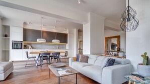 Una sala de estar moderna con sofá, mesa de centro y comedor.