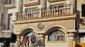 A historic building with a classic architectural style, featuring ornate balconies, large windows, and a prominent entrance with a black door and red curtains. - Marmara Deluxe Hotel (Istanbul)