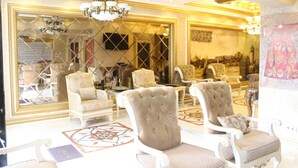 A luxurious room with ornate furniture, a large mirror, and a chandelier. - Marmara Deluxe Hotel (Istanbul)