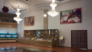 A spacious lobby with a reception desk, chandeliers, and artwork on the walls. - Qingdao Donghai Hotel (Qingdao)