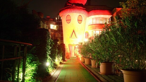 A building with a unique architectural design, featuring a large, illuminated face on the facade. - ALLVITALIS Traumhotel (Karlsruhe)