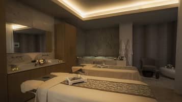 A spa room with two beds, a large mirror, a sink, and a bathtub.