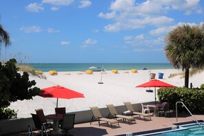 On the beach, white sand, beach cabanas, sun loungers