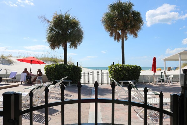 On the beach, white sand, beach cabanas, sun loungers