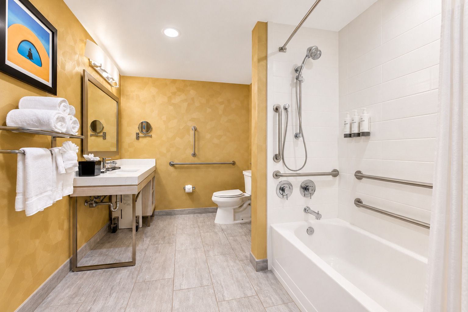 A bathroom with a white bathtub, a shower with a handheld showerhead, a toilet, and a sink with a mirror.