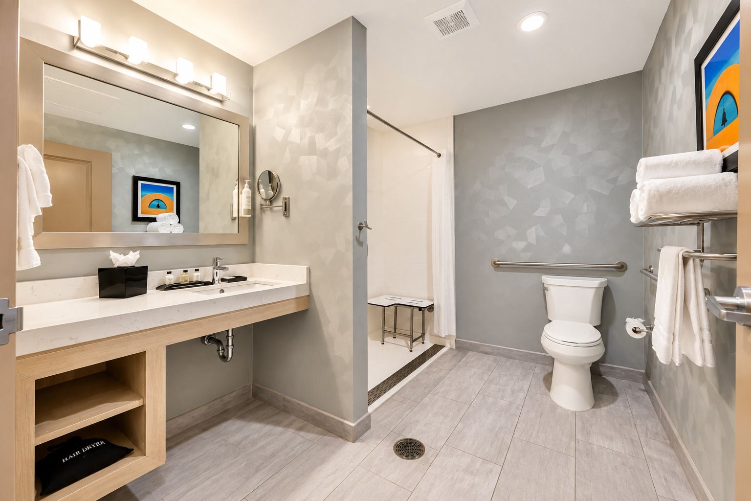 A modern bathroom with a vanity, toilet, and shower area.