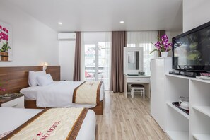 A hotel room with a bed, desk, TV, and a view of the outside. - Vien Dong 3 Hotel (Ho Chi Minh City)