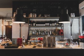 A bar area with shelves of liquor bottles, a chalkboard menu, and a counter with coffee and pastries. - Agriturismo Statale 17 (Poggio Picenze)