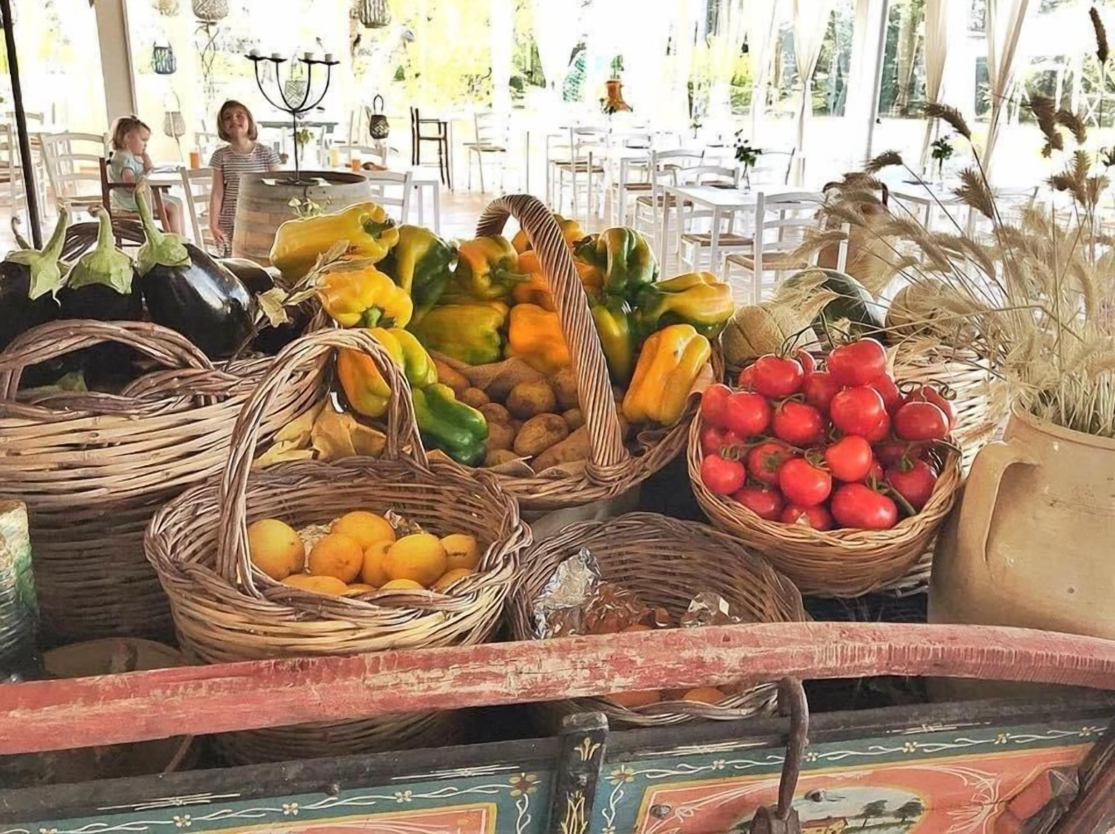 A fruit and vegetable display with baskets containing various produce.