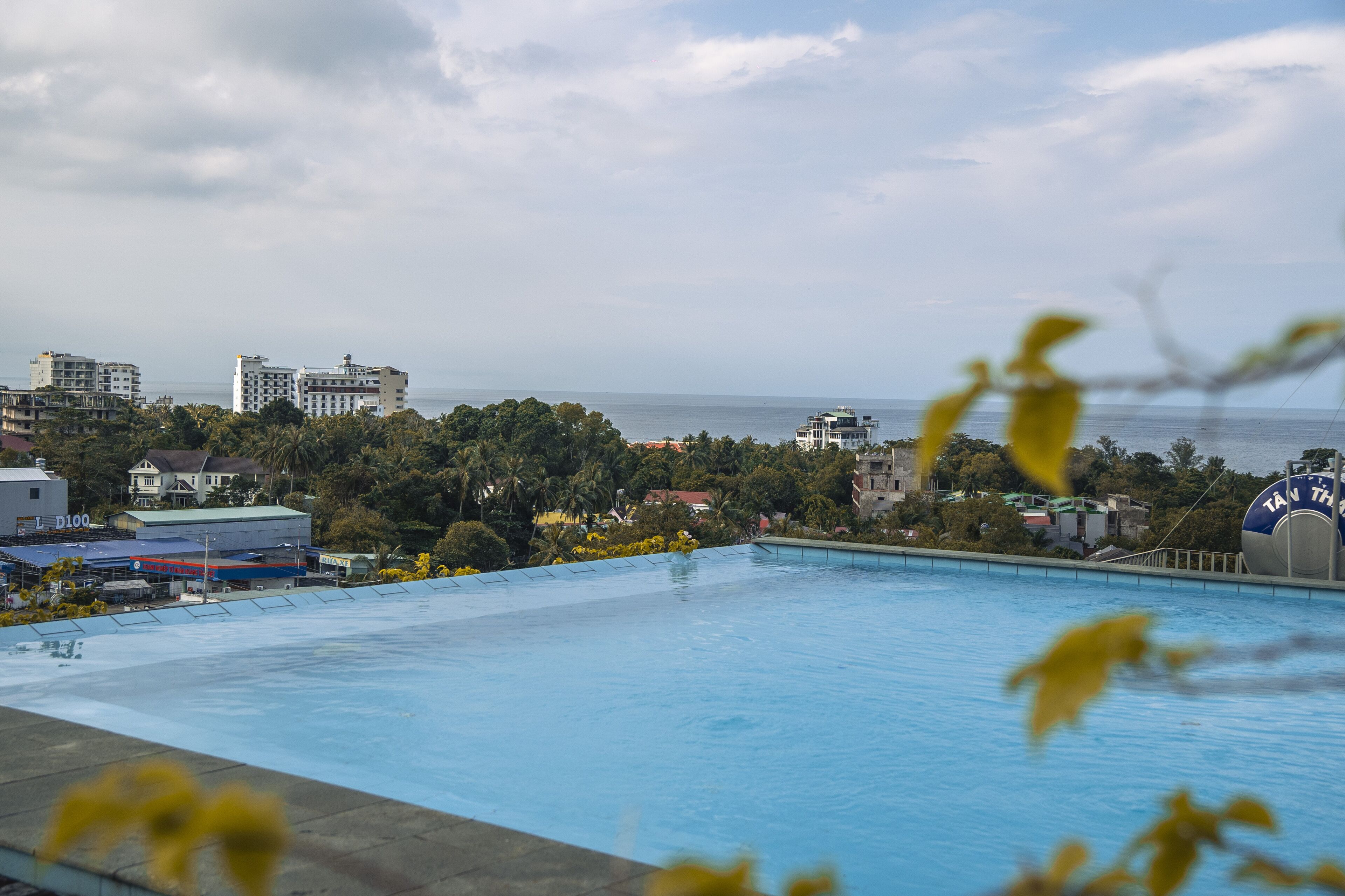 Une piscine à débordement offrant une vue sur l’océan et le paysage urbain.