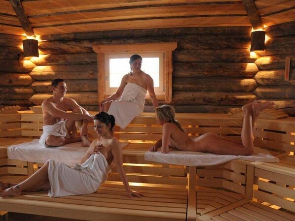 Una sauna con bancos de madera y decoración estilo cabaña de troncos.