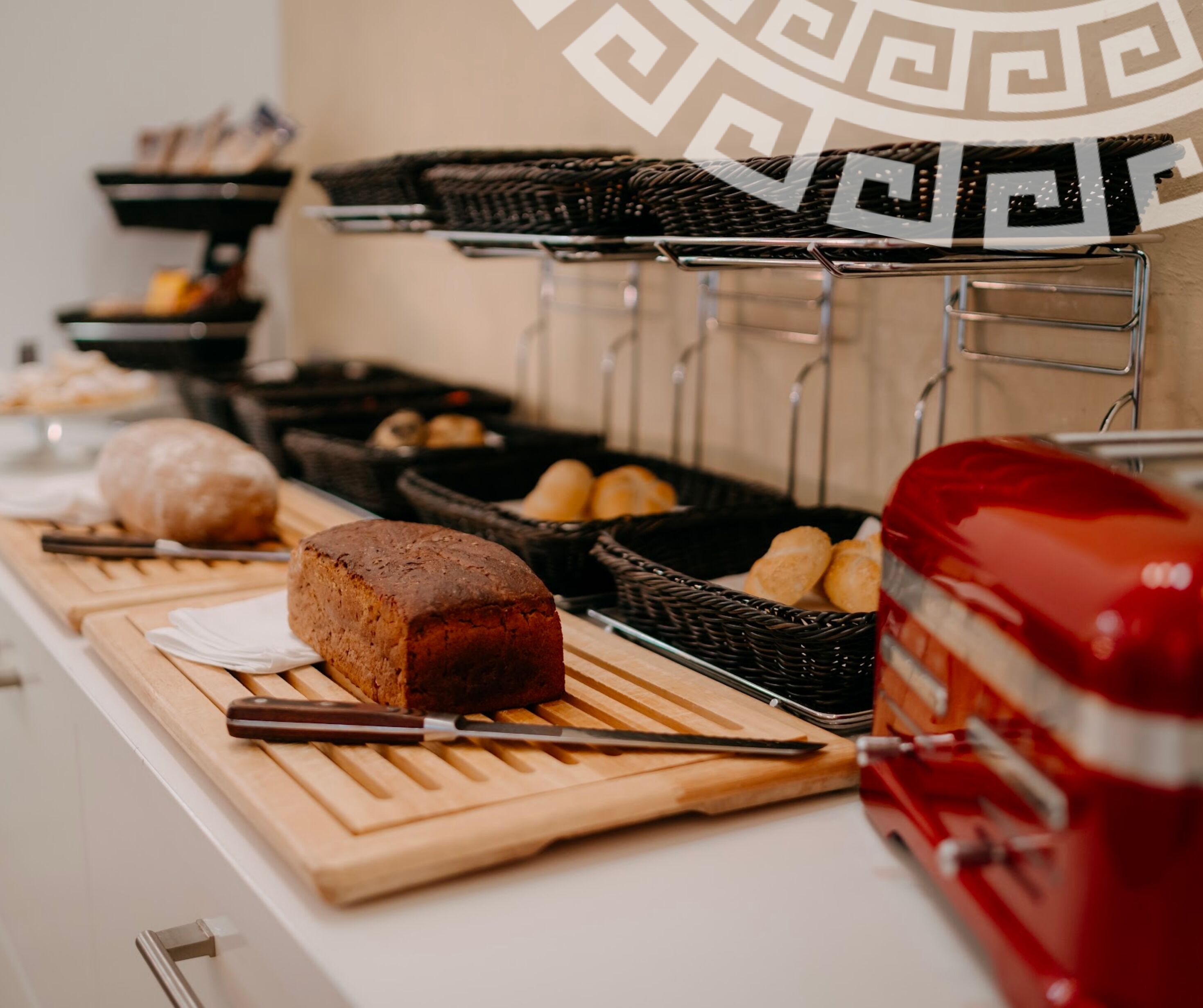 A buffet setup with various food items and a red toaster.