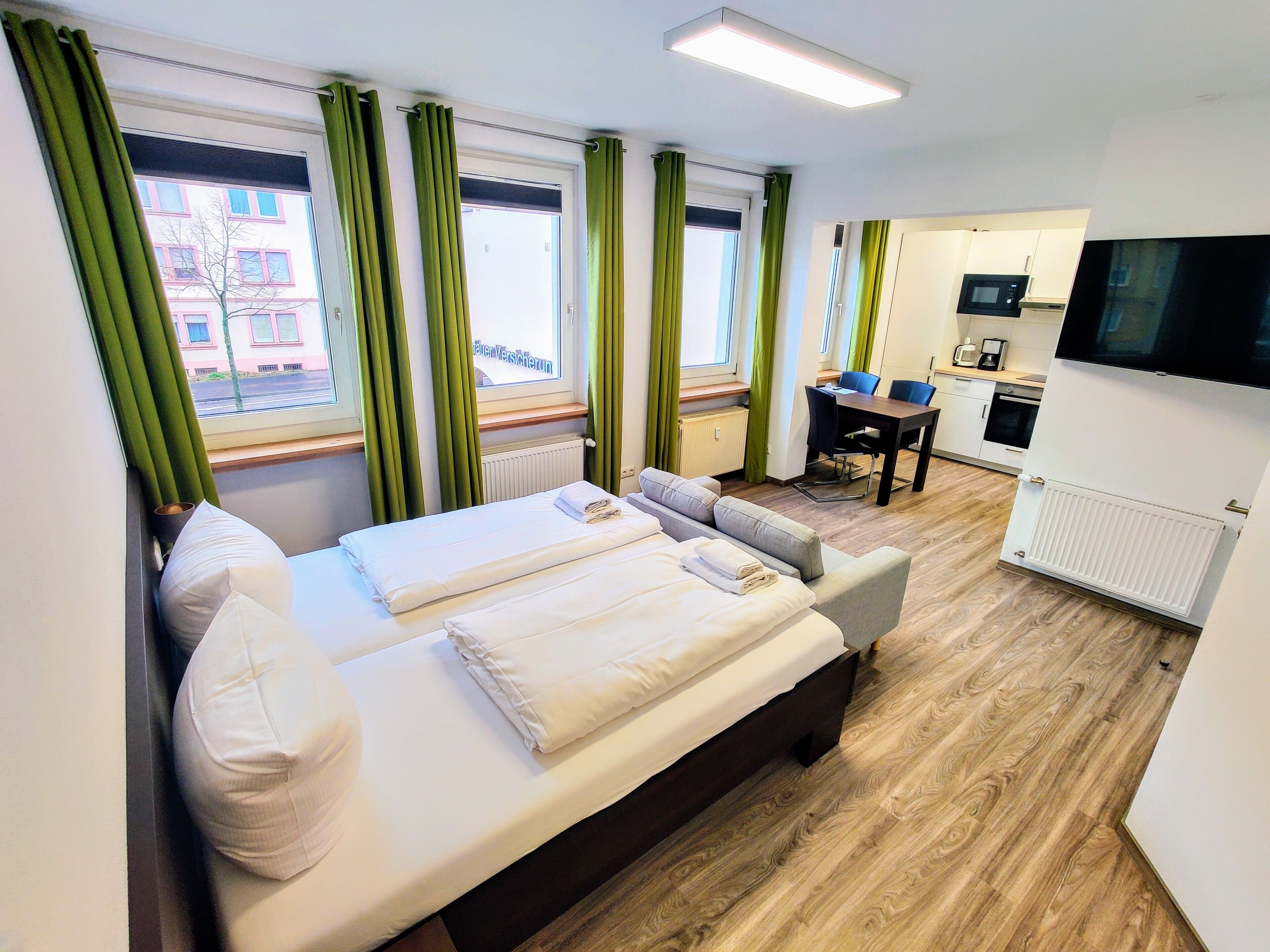 Classic Triple Room | Living area | Flat-screen TV