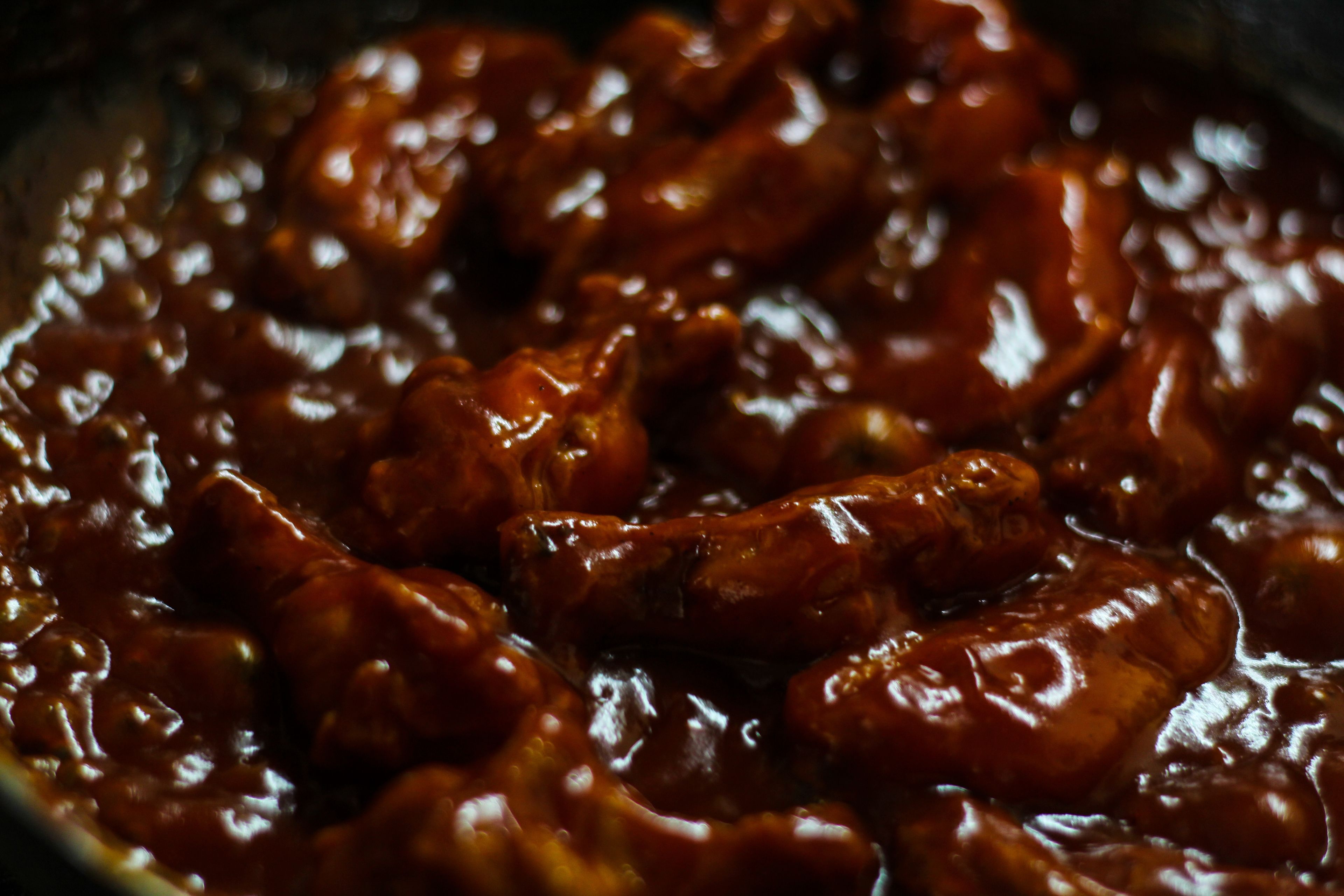 A close-up of a dish with a glossy, dark sauce.