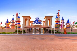 A large, colorful building with multiple towers and a prominent sign reading "RAPHAQUE AQUA." - Pickalbatros Aqua Park Sharm El Sheikh - All inclusive (Sharm El Sheikh)