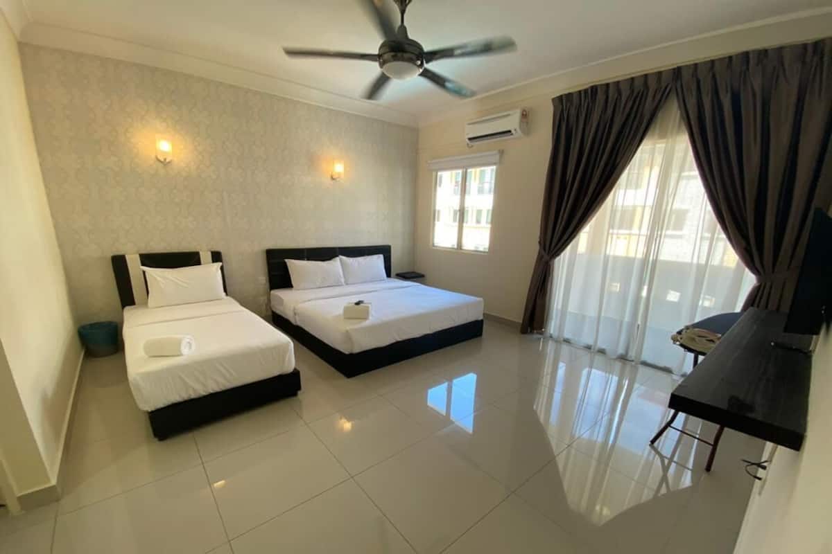 A hotel room with two beds, a ceiling fan, an air conditioning unit, a dining area, and a large window with curtains.