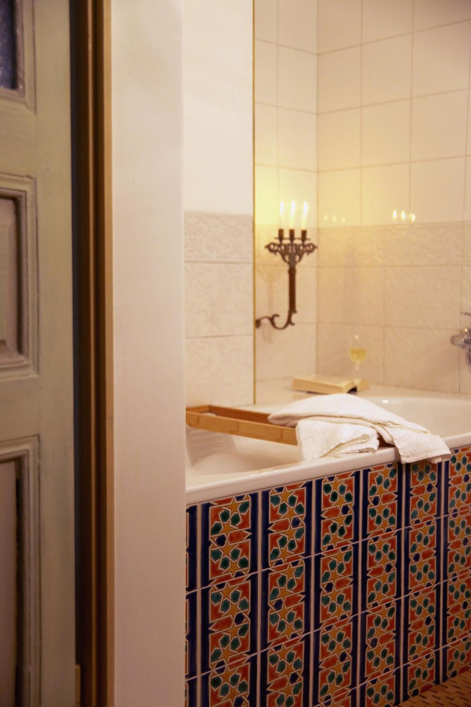 A bathroom with a white sink, a mirror, and a towel rack.