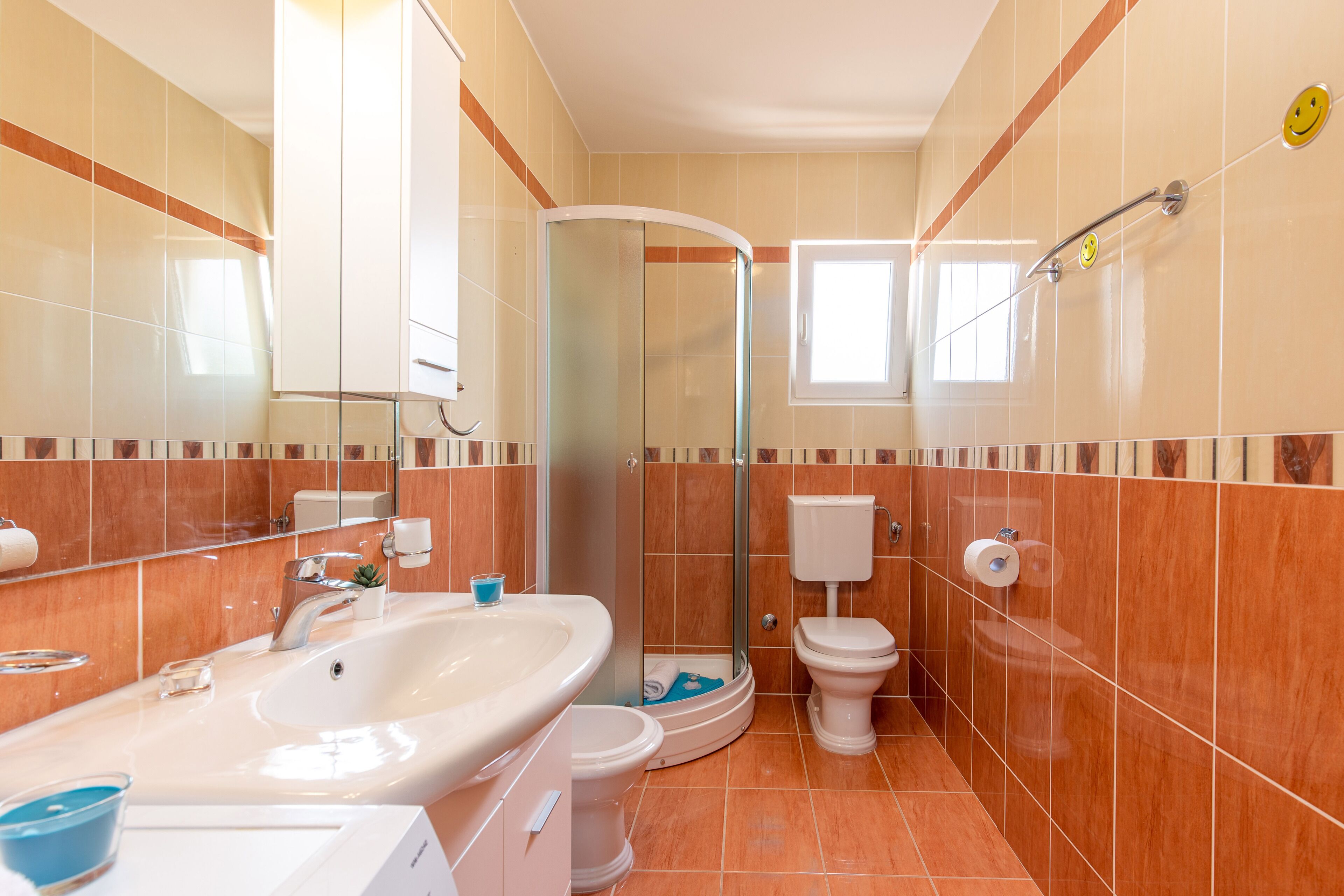 A bathroom with a sink, toilet, and shower.