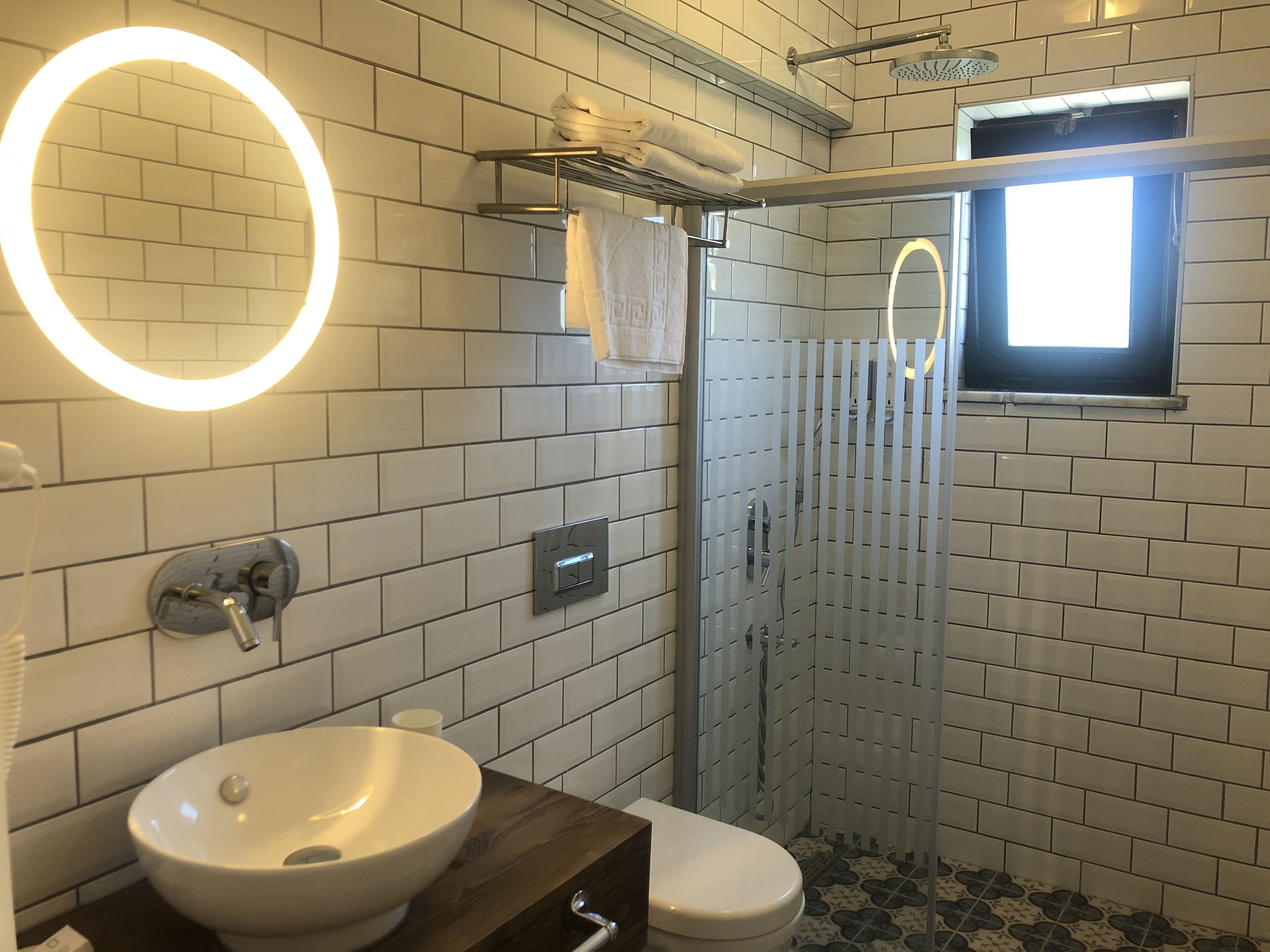 shower, hair dryer, slippers, towels