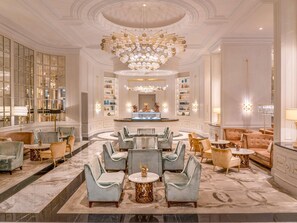 A luxurious lobby with a grand chandelier, marble flooring, and elegant seating arrangements. - Fairmont Amman (Amman)