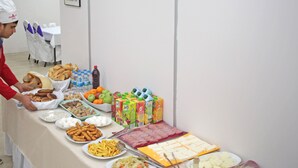 A buffet table with various food items including fruits, cheeses, and snacks. - Peracity Hotel (Ankara)