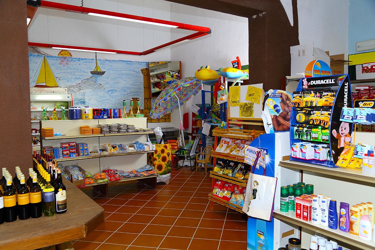 A store with shelves stocked with various products, including bottles and boxes.