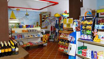 A store with shelves stocked with various products, including bottles and boxes.