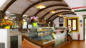 A bakery with a glass display case, brick counter, and wooden ceiling. - Eraclea Minoa Village (Cattolica Eraclea)