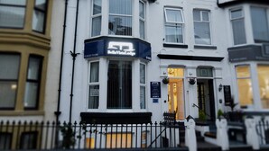 A corner building with a sign for "Belle Vista Lodge." - Bella Vista Lodge (Blackpool)