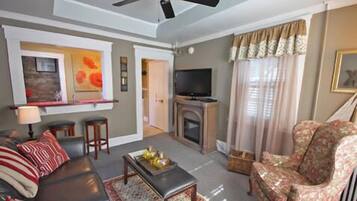 Suite, 1 King Bed, Kitchenette, Garden Area | Living area | Flat-screen TV