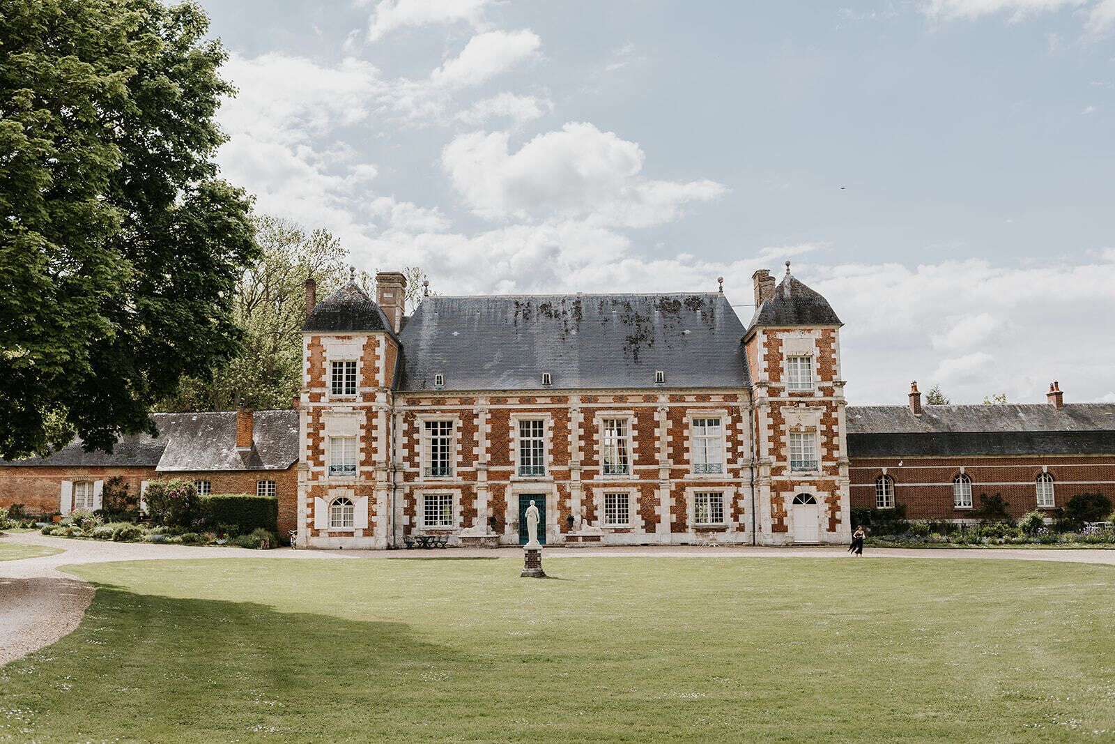 A large, historic building with a symmetrical facade, multiple windows, and a central entrance.