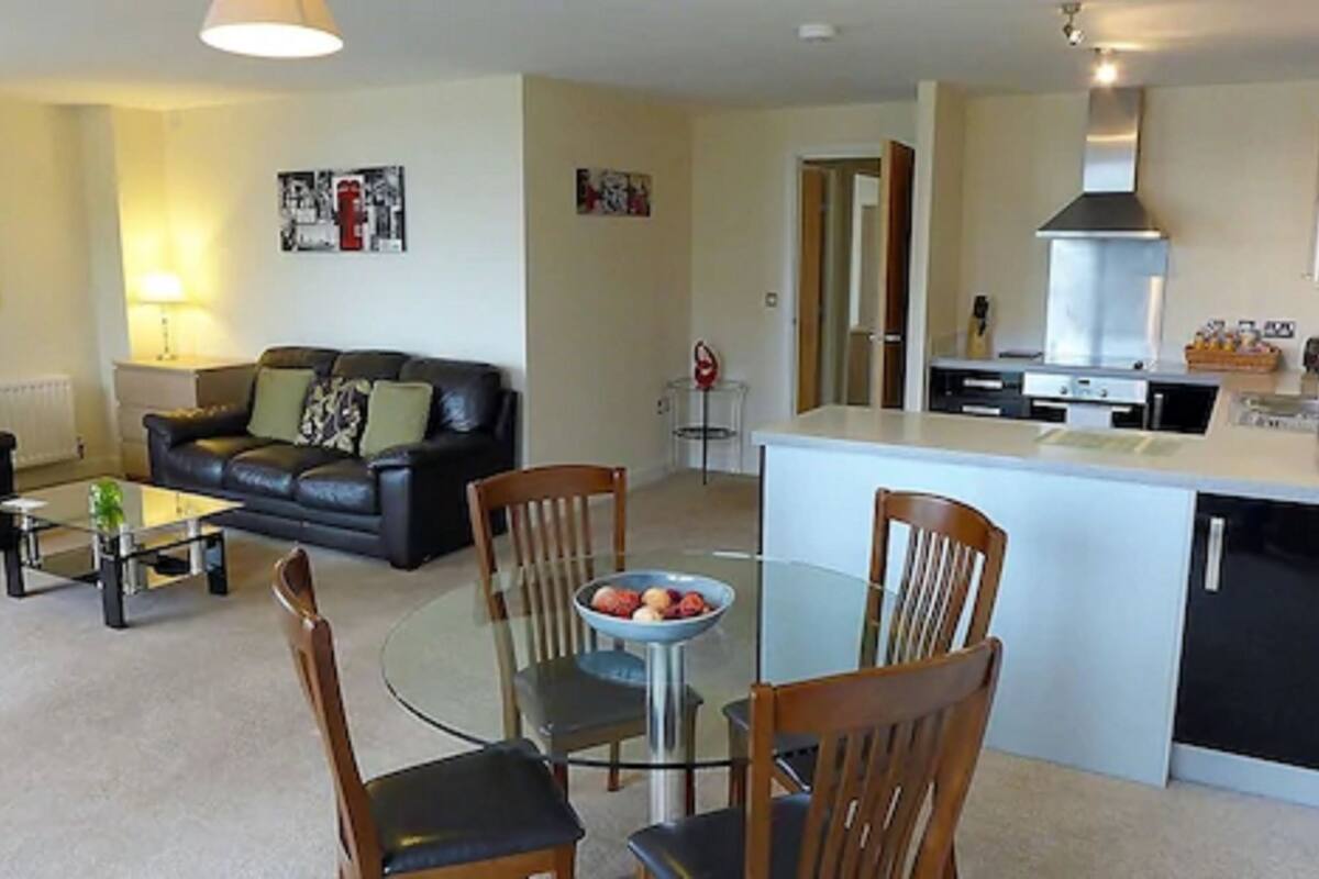 A compact living space with a dining area, kitchen, and seating.