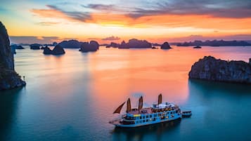 Experience the serenity of a leisurely river cruise with breathtaking views of surrounding rock formations and islands.