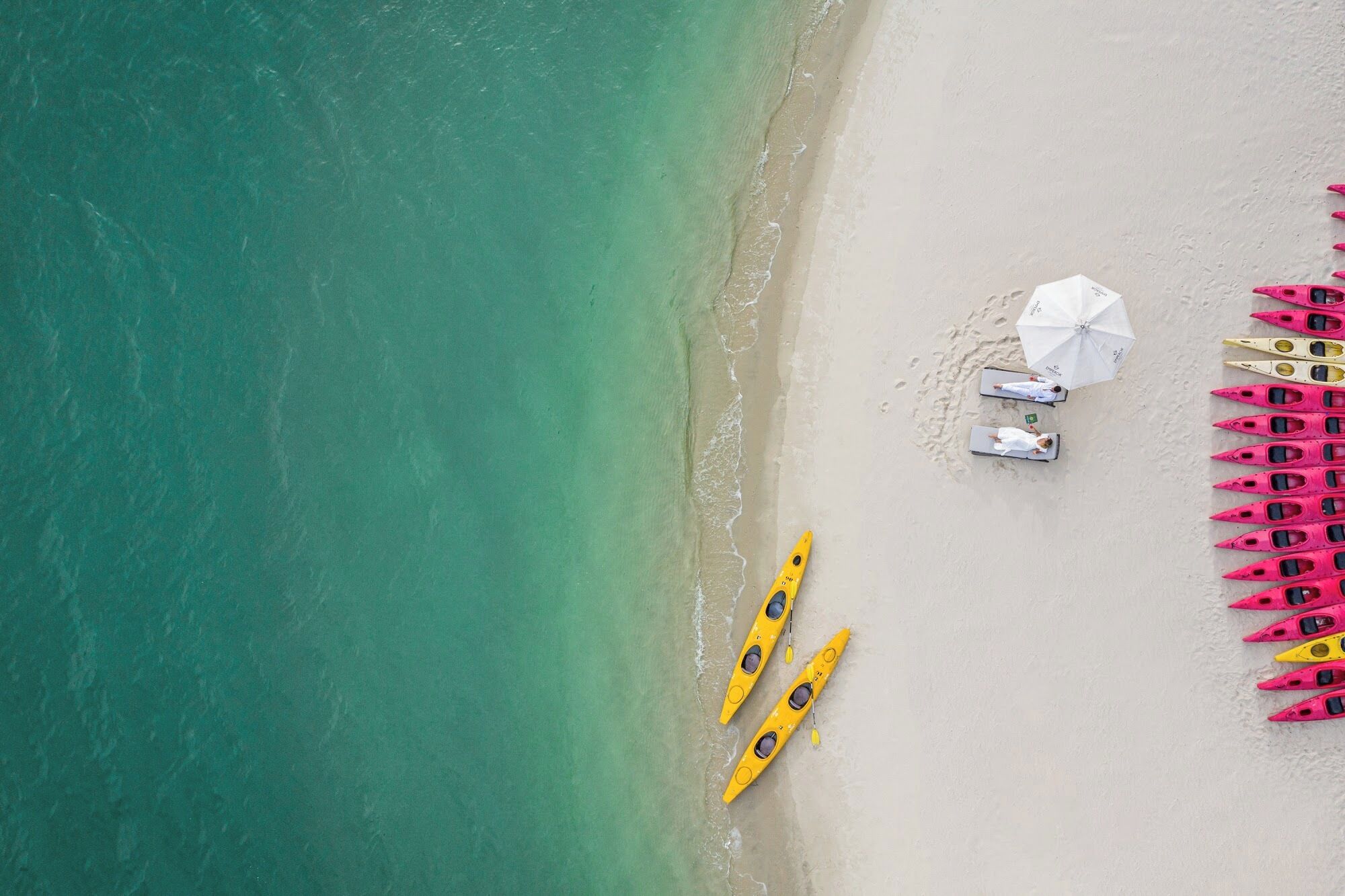 On the beach, white sand, beach towels, sailing