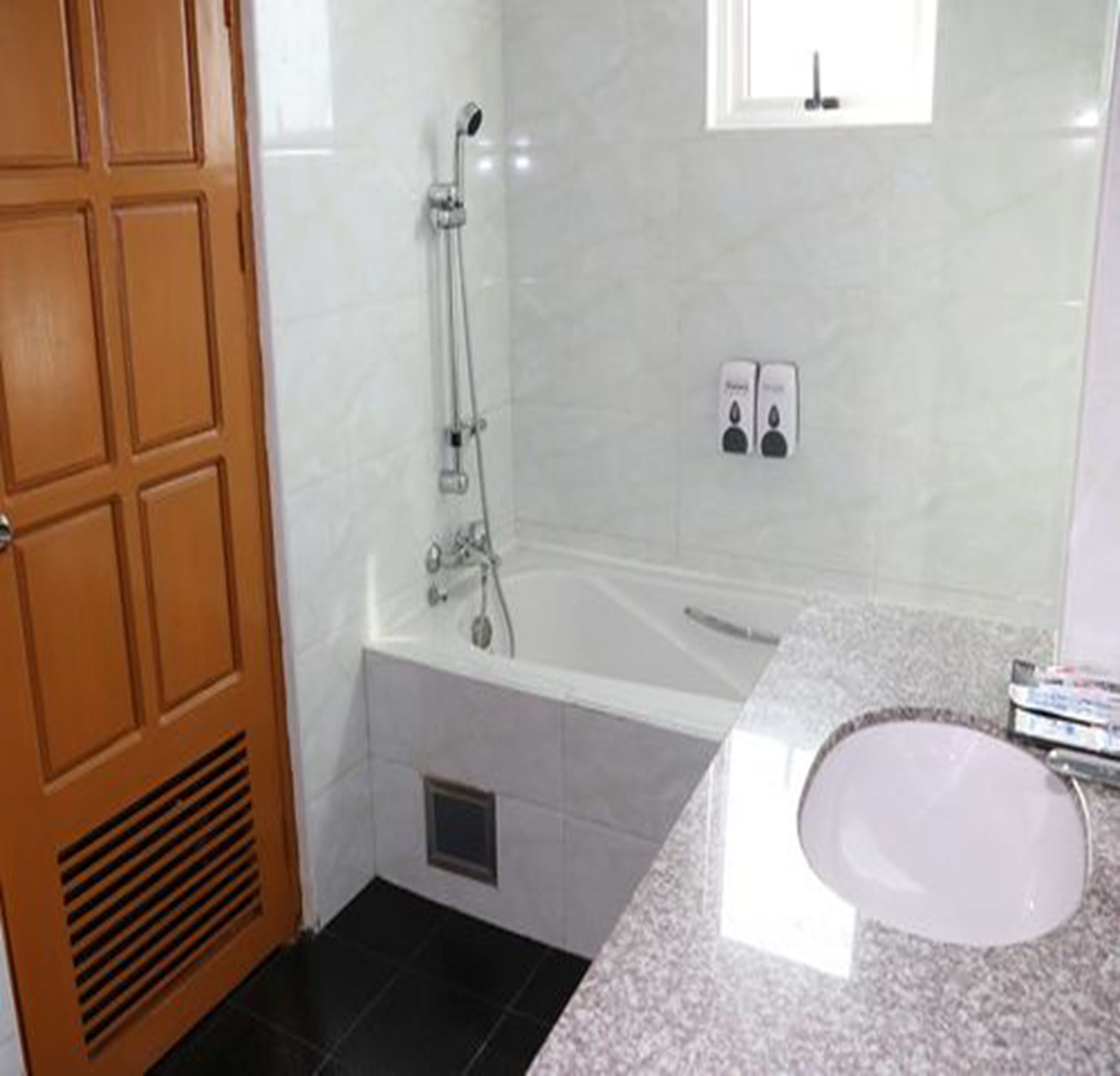deluxe room | bathroom | deep-soaking bathtub, rainfall showerhead, free toiletries, towels