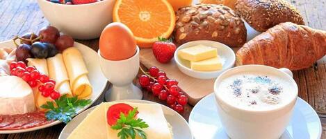A breakfast spread with various foods and drinks.